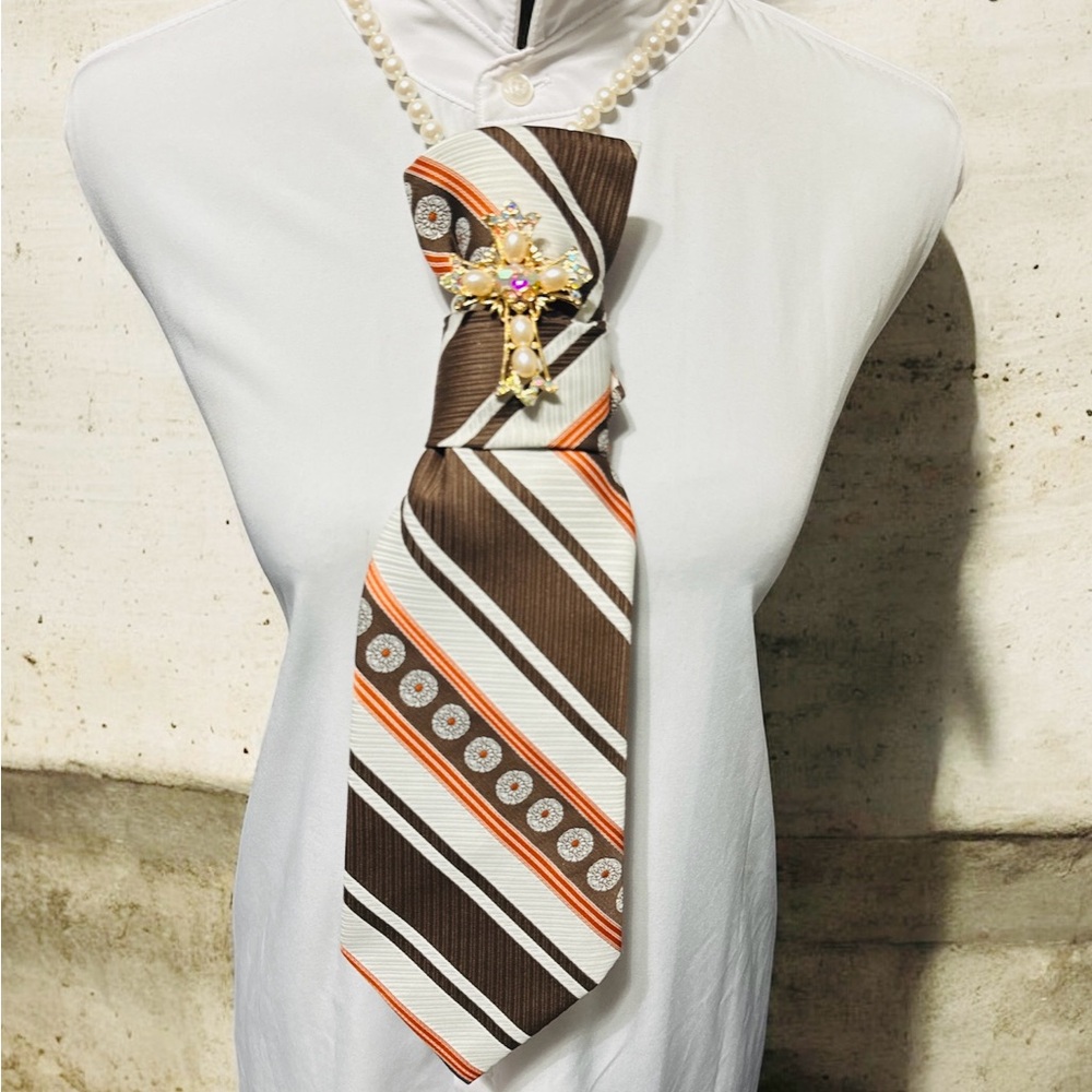 Elegant Brown and Orange Striped Necktie with Gold Cross Brooch